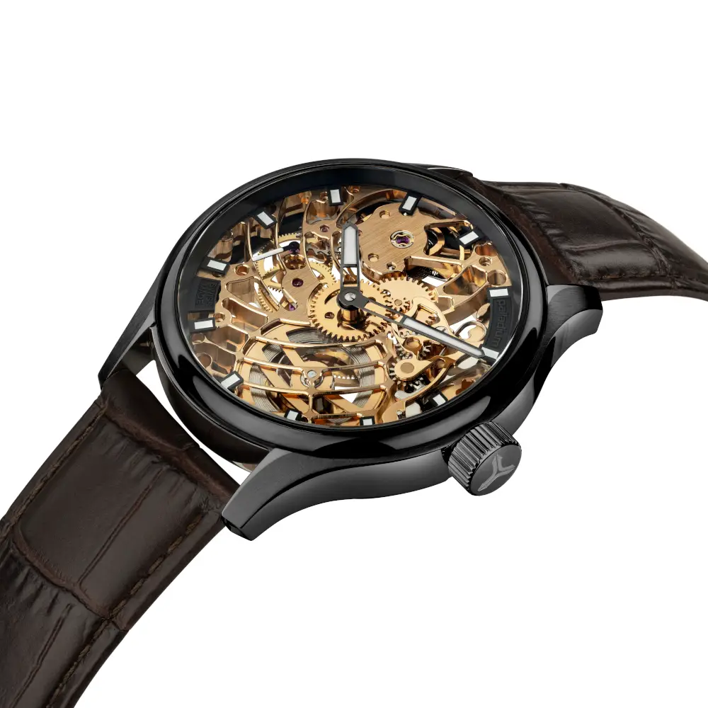 Skeleton wristwatch with a gold-tone mechanical movement visible through the case, black bezel, and brown leather strap